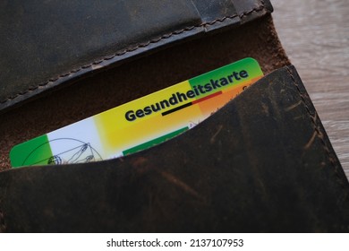 Frankfurt, Germany - January 2022: Leather Wallet With Public Health Insurance Cheaper, Insurance Card In German, Concept Medical Support In Country And On Trip To Europe