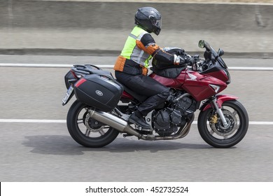 FRANKFURT, GERMANY - JULY 12, 2016: Motorcyclist on a Honda motorcycle driving on the highway in Germany - Shutterstock ID 452732524