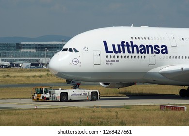 FRANKFURT, GERMANY - JUN 09th, 2017: Airbus A380 of Lufthansa with registration D-AIMH moves on taxiway by tow truck before departure from FRA airport