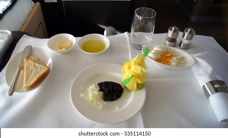 FRANKFURT, GERMANY - SEPTEMBER 2014: Traveling Lufthansa First Class In A Boeing 747-400 Upper Deck - Service With Black Caviar, Toast, Onions And Eggs.