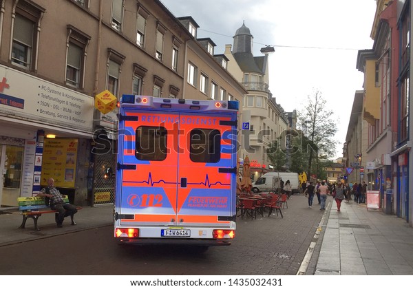 Frankfurt am Main,\
GERMANY, APRIL 2019: 112 emergency ambulance with flashing lights\
on the streets of\
Frankfurt