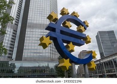 Frankfurt am Main, Germany - June 28, 2020: The Euro-Skulptur (German for Euro sculpture) set up in front of the European Central Bank, electronic signage showing a Euro sign and twelve stars around