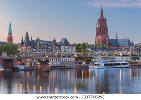 Frankfurt St. Bartholomew's Cathedral and city embankment at sunset.