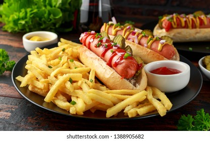 frankfurter Sausage hotdogs with french potato fries, chips crinkle cut gherkins, ketchup and mustard. fast food - Powered by Shutterstock