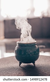 Frankincense burning on a hot coal. Frankincense is an aromatic resin, used for religious rites, incense and perfumes, incense smoke (color toned image)
