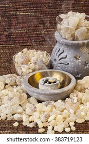 Frankincense burning on a hot coal. Frankincense  is an aromatic resin, used  for religious rites, incense and perfumes.