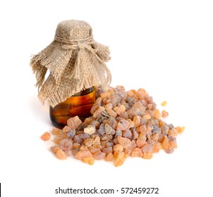 Frankincense olibanum resin with pharmaceutical bottle. Isolated on white background.