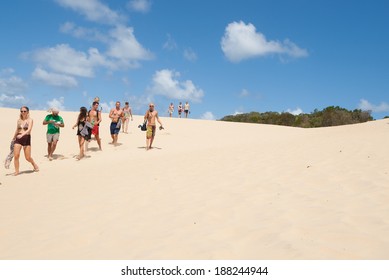 FRASER ISLAND, AUSTRALIA - MARCH 13 - Tourists Walk Across The Desert Like Sand Blow At Lake Wabby, Fraser Island On March 13, 2014 In Fraser Island Australia.