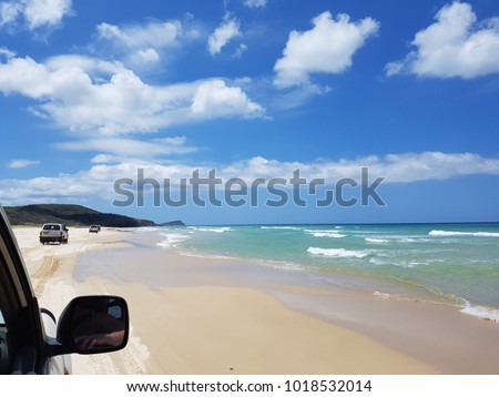 Fraser Island, Queensland, Australia, a photo taken from 4WD while driving on the beach during the low tide. Outdoor activity, amazing adventure, going from soft sand to hard sand and avoiding waves.