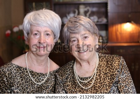Fraternal twins wearing animal print matching outfits