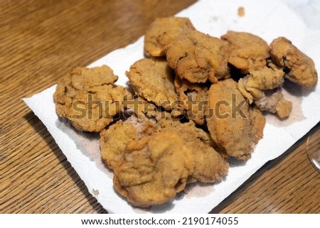 Frayed Bulls Testicles on a Table - Rocky Mountain Oysters Special plate