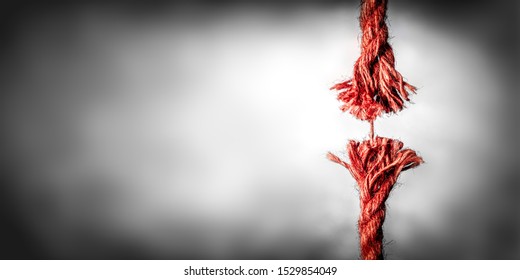 Frayed Red Rope Hanging By Last Thread On Black And White Background With Copy Space
