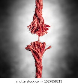 Frayed Red Rope Hanging By Last Thread On Black And White Background 