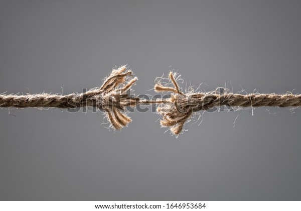 Frayed rope about to break\
concept for stress, problem, fragility or precarious business\
situation