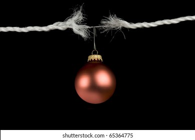 Frayed Rope With Christmas Bulb Holiday Stress Concept Isolated On Black Background