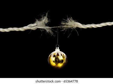 Frayed Rope With Christmas Bulb Holiday Stress Concept Isolated On Black Background