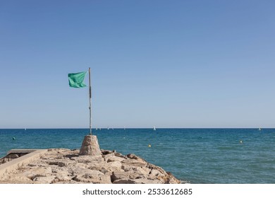 Free beach, sunny day, sea and clear blue sky. Lifeguard, security, guard. green flag. Bathing is allowed. - Powered by Shutterstock