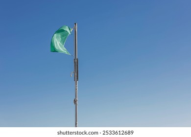 Free beach, sunny day, sea and clear blue sky. Lifeguard, security, guard. green flag. Bathing is allowed. - Powered by Shutterstock