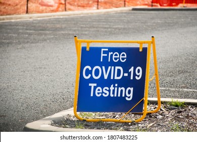 Free COVID-19 Testing. Drive Through Testing Clinic Sign On A Road.