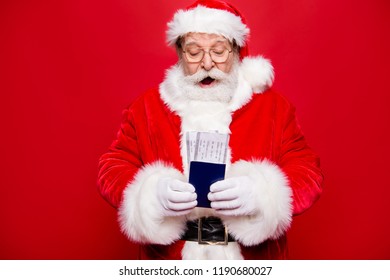 Free december noel time on journey travel! Finally check-in departure arrival boarding pass or voucher in aged excited grandfather stylish Santa white beard hands isolated on vivid red background