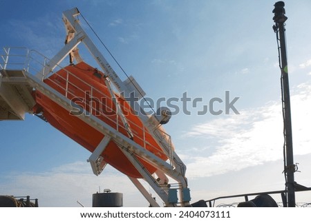 Free fall life boat secured on the boat deck of a ship at sea