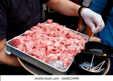 Free Food Sample Tasting, Salesman Serving Fresh Otoro Tuna Fish Sampling To Customer In Fish Market, Offering Free Sample Product Increasing Sales.