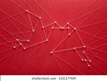 Free Love Concept On Red Background. Network Of Pins And Threads In The Shape Of Two Birds Breaking Free And Kissing Symbolising Love And Freedom Of Choice.