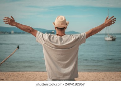 free man relaxed on the beach with arms raised - Powered by Shutterstock