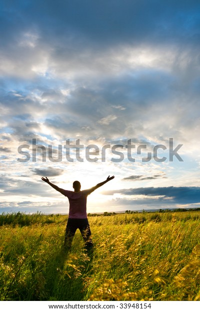 Free Man Standing Before Sunrise Stock Photo (Edit Now) 33948154