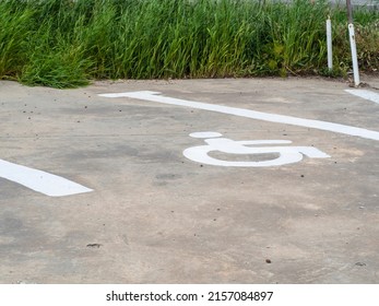 Free parking spaces for the disabled in the parking reserved for people with disabilities. white stripes on the asphalt and a wheelchair symbol painted on a dedicated parking space for the disabled.