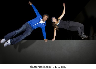 Free Runner Doing Parkour At Night On A Rooftop