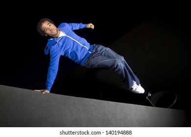 Free Runner Doing Parkour At Night On A Rooftop