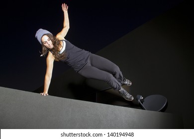 Free Runner Doing Parkour At Night On A Rooftop