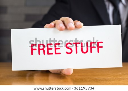 Free stuff, message on white card and hold by businessman