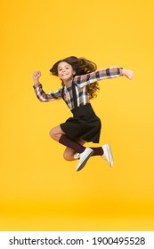 Free style. Happy schoolchild in midair yellow background. Free from school. Summer holidays. Free time. All good things are wild and free.