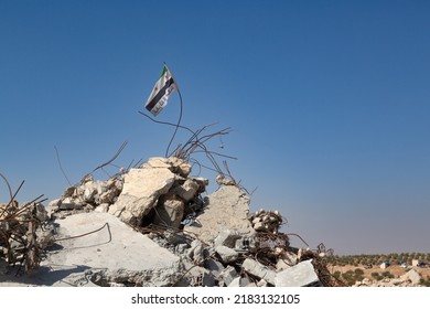 A Free Syrian Army Flag Hanging From The Rebar Of A Building Destroyed By Plane Bombing. An Area Cleared Of ISIS. Jarablus, Aleppo, Syria-October 7, 2016.