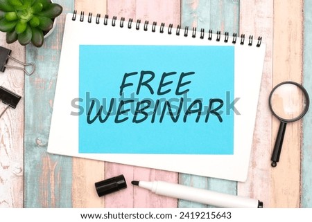 FREE WEBINAR on blue paper composition with stationery on color background. idea of providing educational online session without charge, conveying an opportunity for learning and skill development