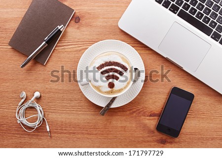 Free wifi area sign on a latte coffee in a business table
