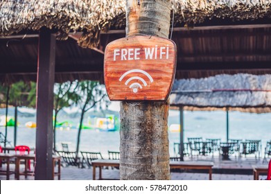 Free WiFi Arrow On The Beach. Internet Everywhere Concept