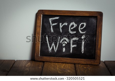 Free wifi sign. Wooden table.