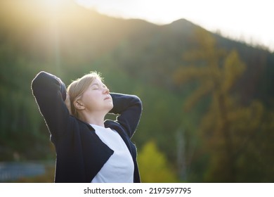Free woman breathing clean mountain air. Fresh air, healthy lifestyle concept. - Shutterstock ID 2197597795
