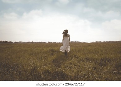 free woman running happy in a field