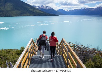 Free Women Walking Are Looking At The Argentino Lake 