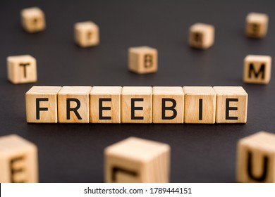 Freebie - word from wooden blocks with letters, given free freebie concept, random letters around white background