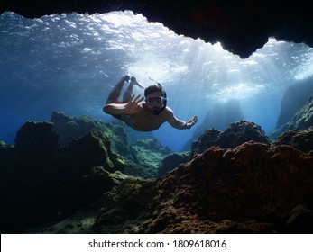 Freediver Apnea Man Free Diving In A Cave Underwater With Nice Lightning 