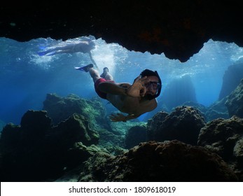 Freediver Apnea Man Free Diving In A Cave Underwater With Nice Lightning 