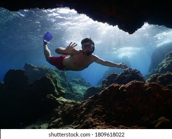 Freediver Apnea Man Free Diving In A Cave Underwater With Nice Lightning 