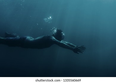 Freediver Sporty Young Man Swimming Underwater, Breaststroke.