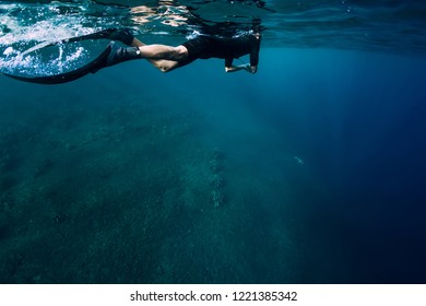 Freediver In Wetsuit Swimming In The Ocean