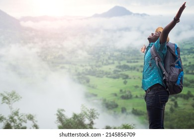 Freedom african traveler man carrying a backpack stands at the top of a mountain on a foggy day.Adventure travel and success concept - Powered by Shutterstock